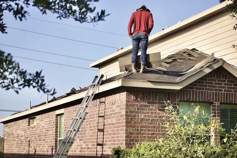 Professional roofer working on a residential roof in North Scituate